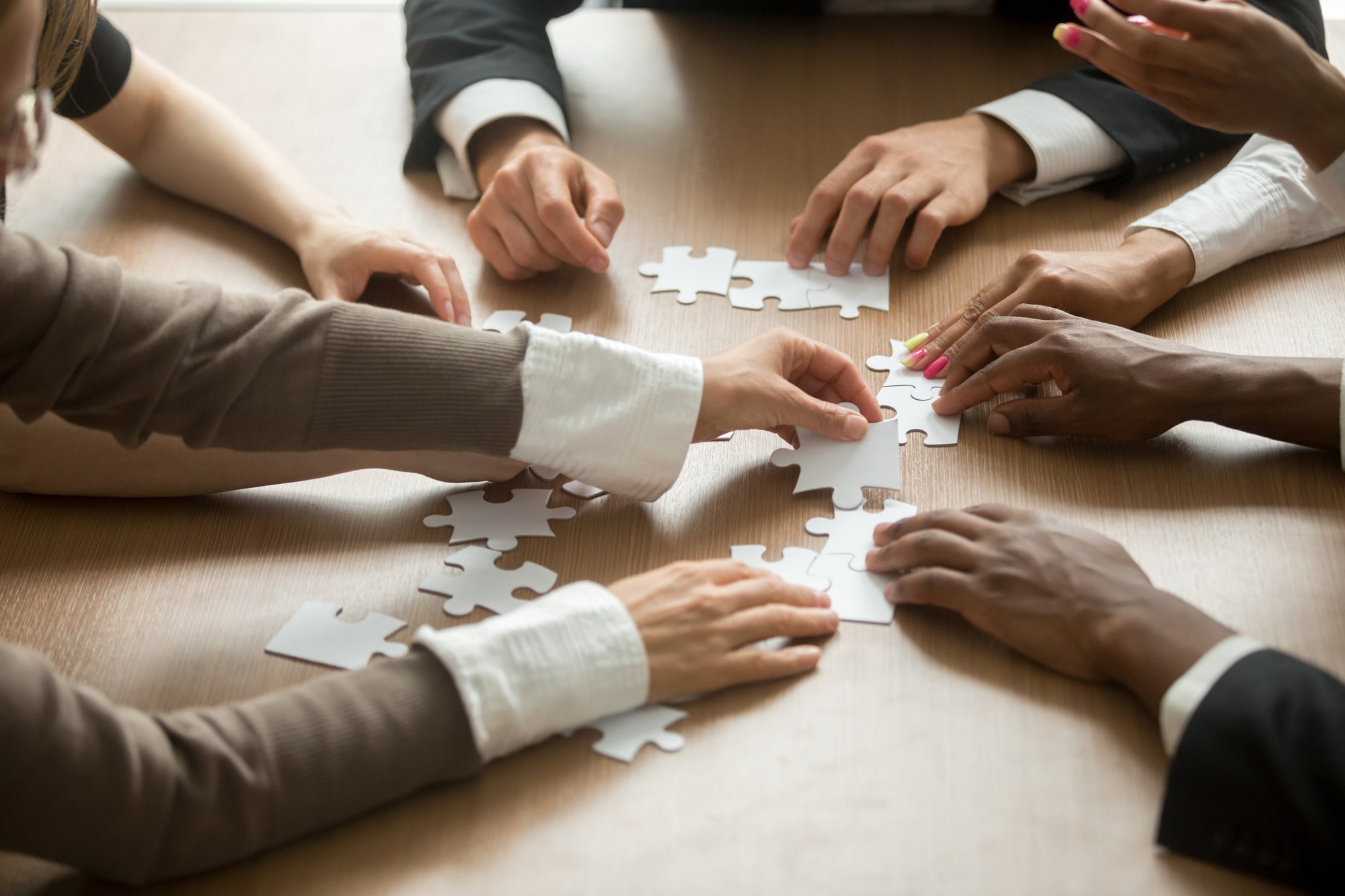 Business People Helping Assembling a Puzzle